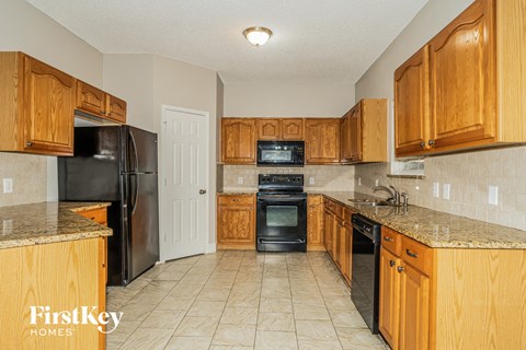 a kitchen with wooden cabinets and black appliances