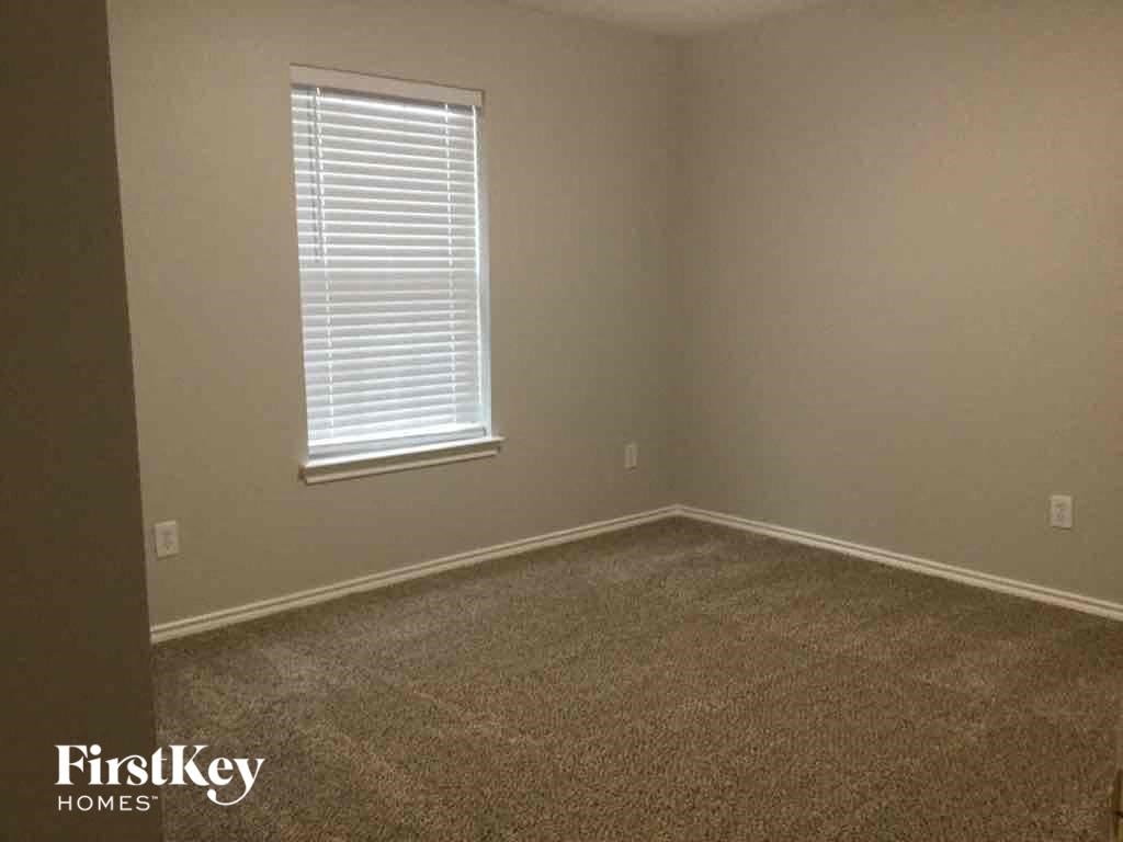 a room with a carpeted floor and a window