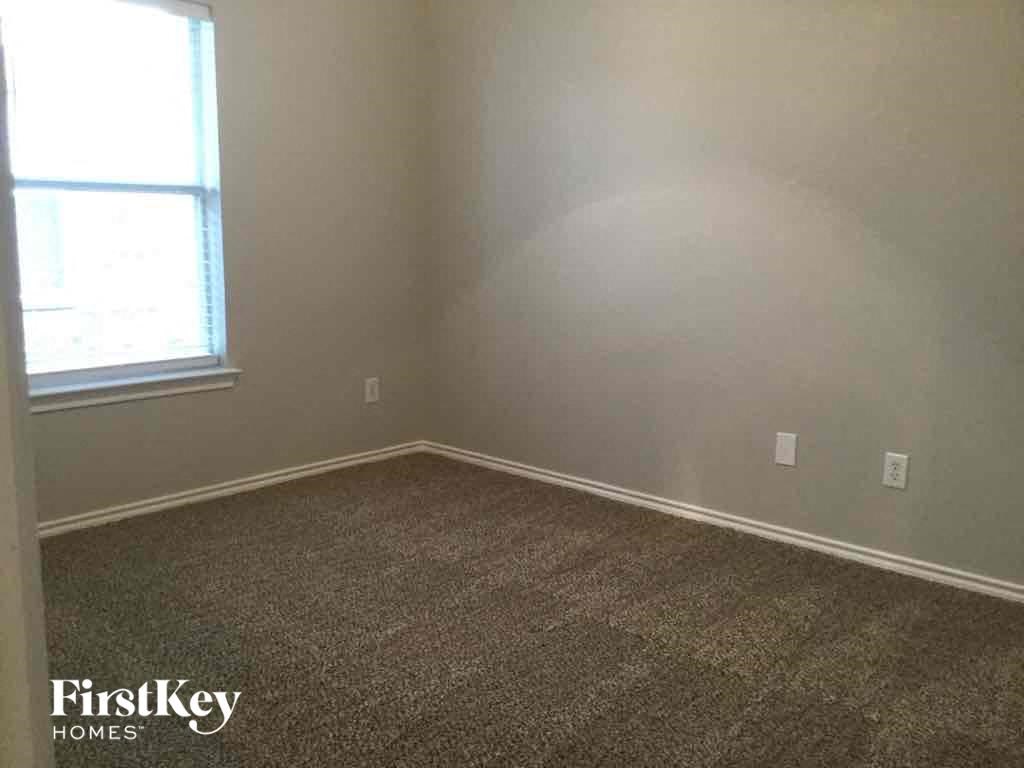 a room with a carpeted floor and a window