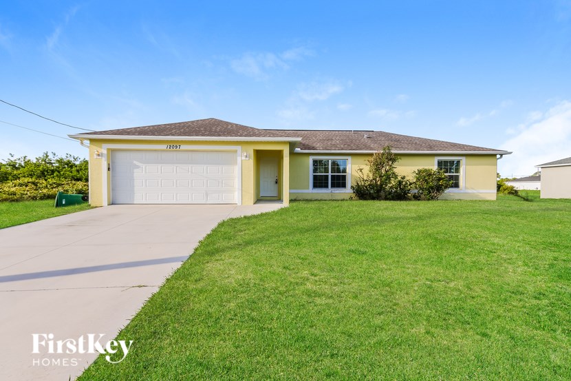 A yellow house with a garage door that says 2021 on it.