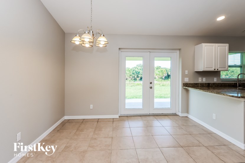 A kitchen with a white counter and a white fridge.