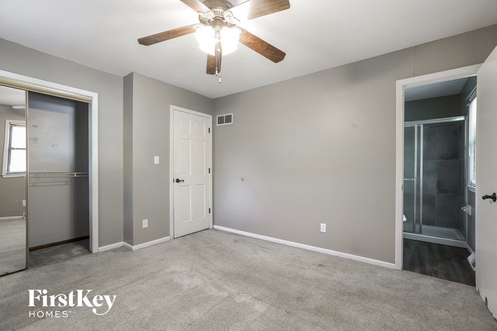 a empty room with a ceiling fan and a closet