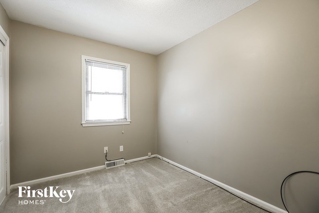 a room with a carpeted floor and a window