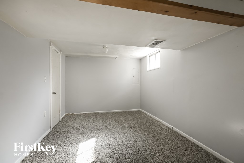 a empty room with white walls and a window