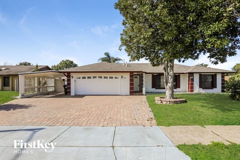 A house with a tree in front of it.