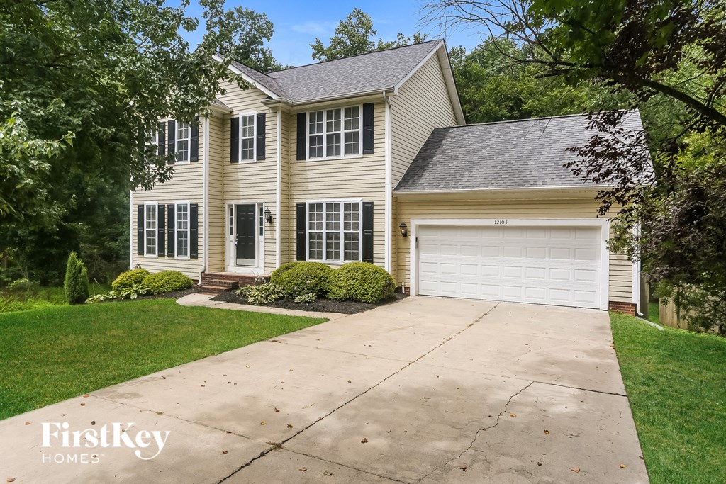 a white house with a driveway and a white garage door