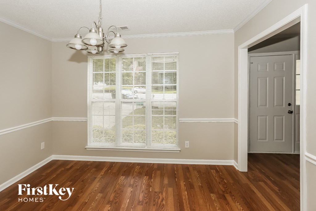 the living room after remodeling with hardwood flooring and a window