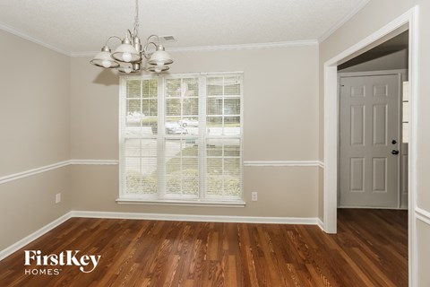 the living room after remodeling with hardwood flooring and a window
