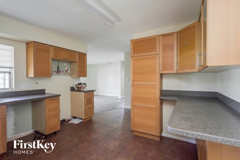 A kitchen with wooden cabinets and a countertop.