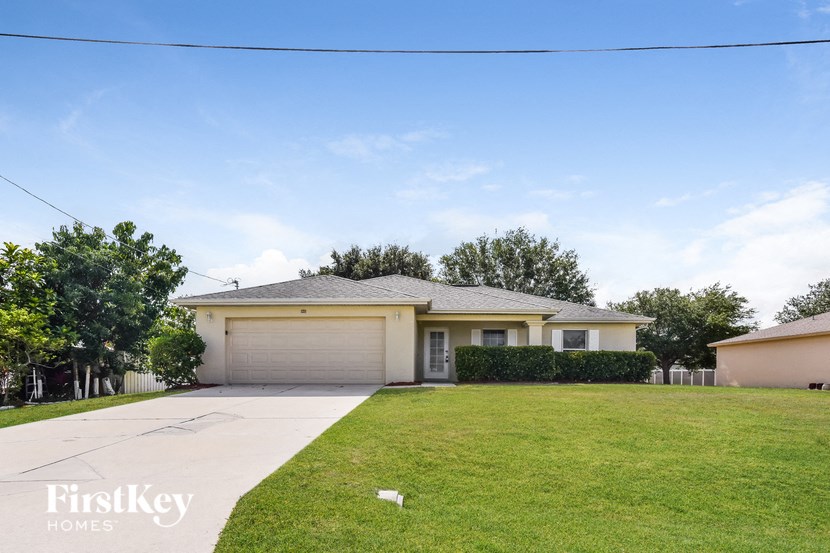 a suburban house with a lawn and a driveway