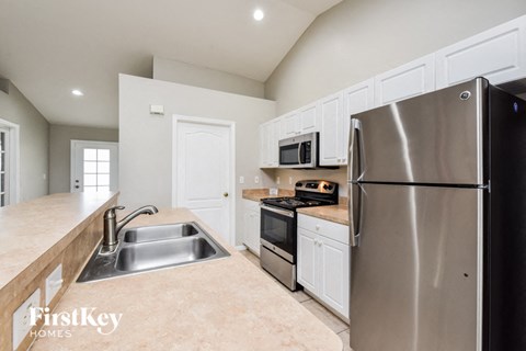 a kitchen with stainless steel appliances and white cabinets