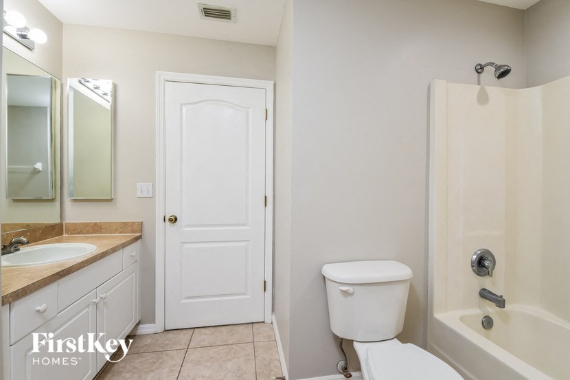 a bathroom with a toilet and a sink and a shower