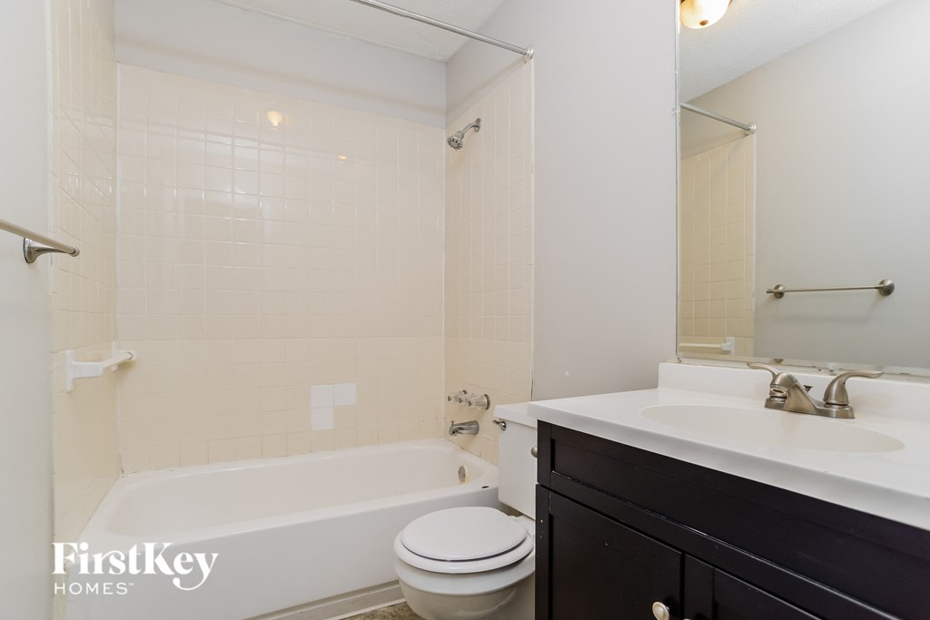 a bathroom with a sink toilet and bath tub