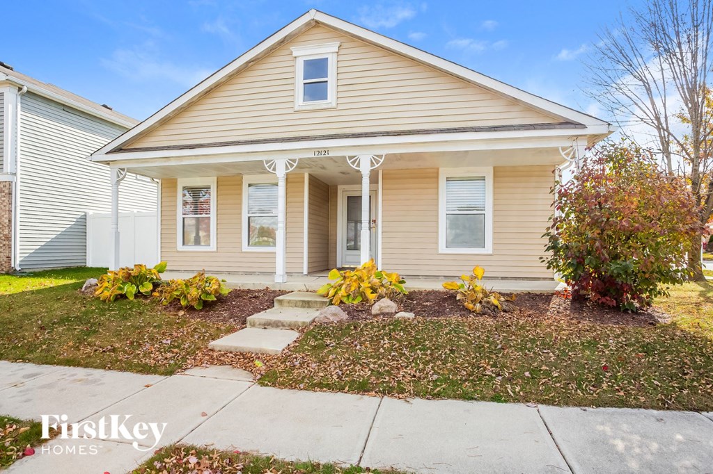 A house with a front yard and a clear sky.