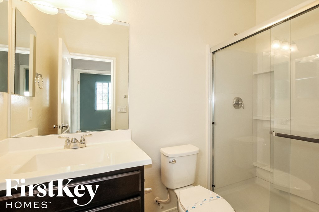 a bathroom with a toilet and a sink and a shower