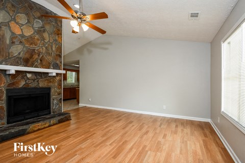 a living room with a fireplace and a wooden floor