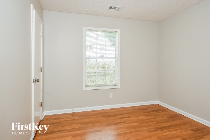 a room with a hard wood floor and a window