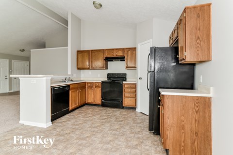 a kitchen with black appliances and wooden cabinets