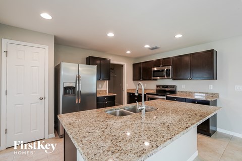 a kitchen with granite counter tops and stainless steel appliances