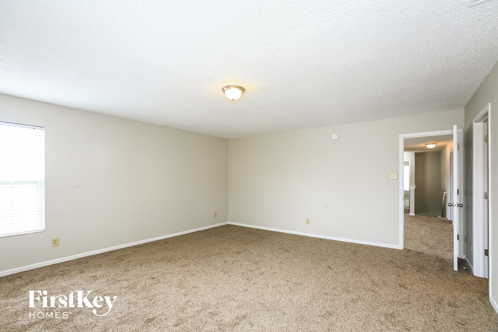 A room with a carpeted floor and a ceiling light.