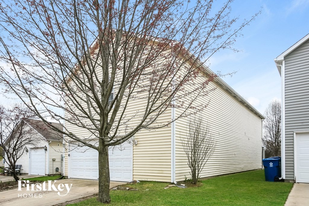 A house with a tree in front of it.