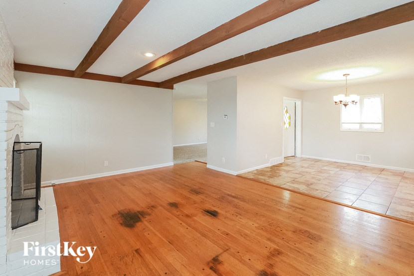 A room with wooden floors and a fireplace.