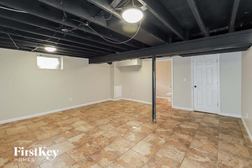 A room with a tile floor and a white door.