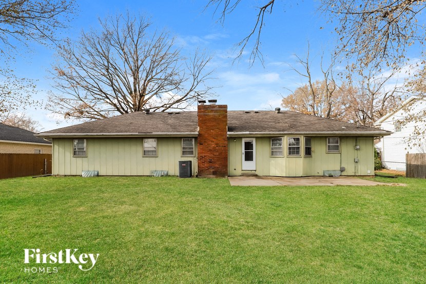A house with a large lawn in front of it.