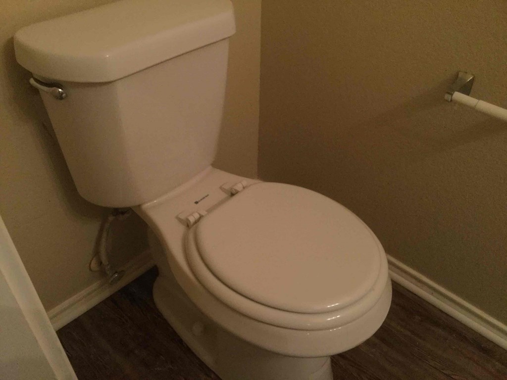 a white toilet in a bathroom with the seat down