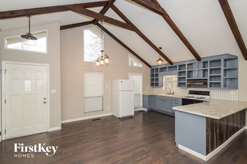 the kitchen is open to the living room and dining room