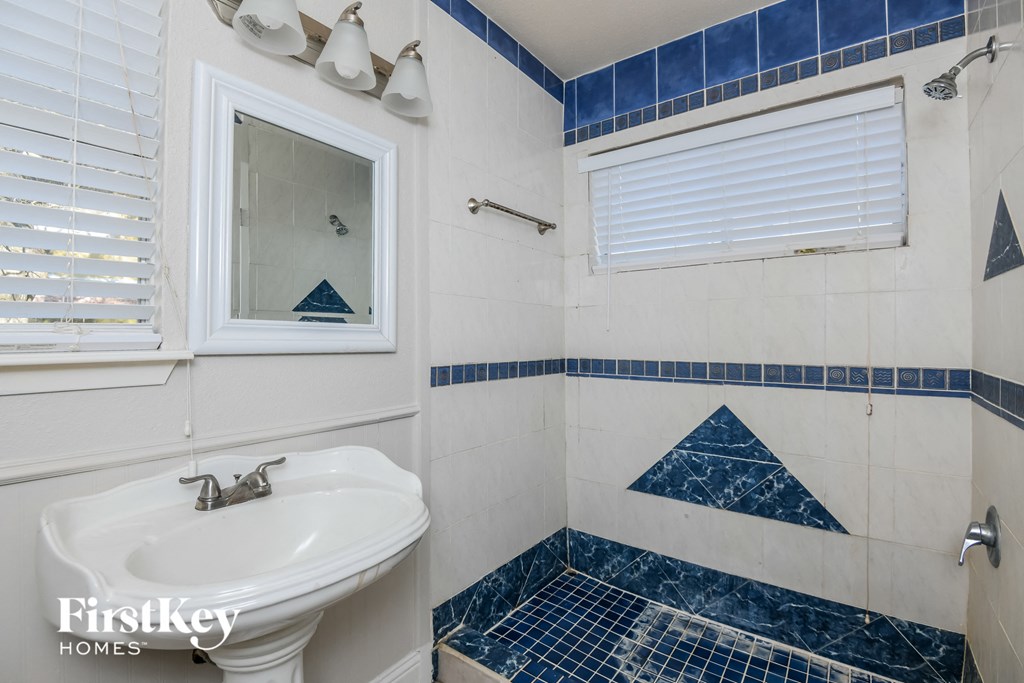 a small bathroom with a sink and a mirror