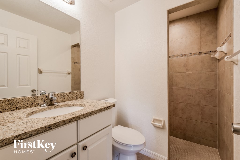 a bathroom with a sink toilet and a shower
