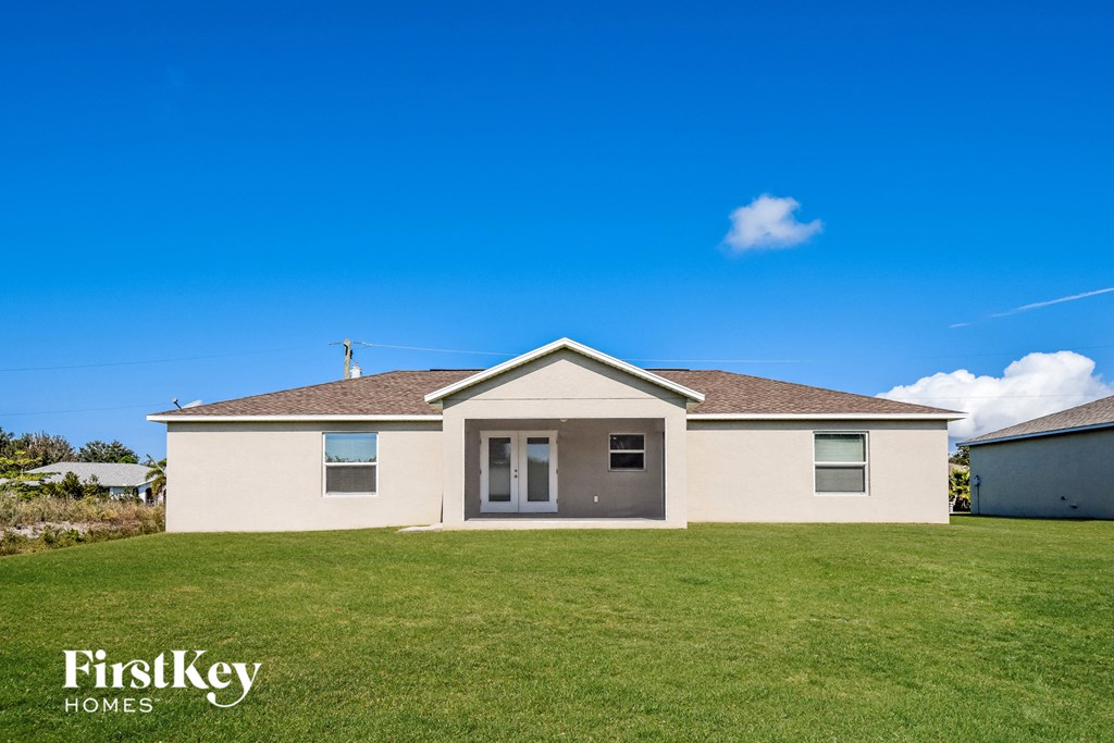 a cream colored house with a blue sky in the background