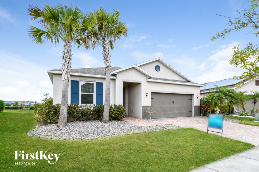 a house with palm trees in front of it