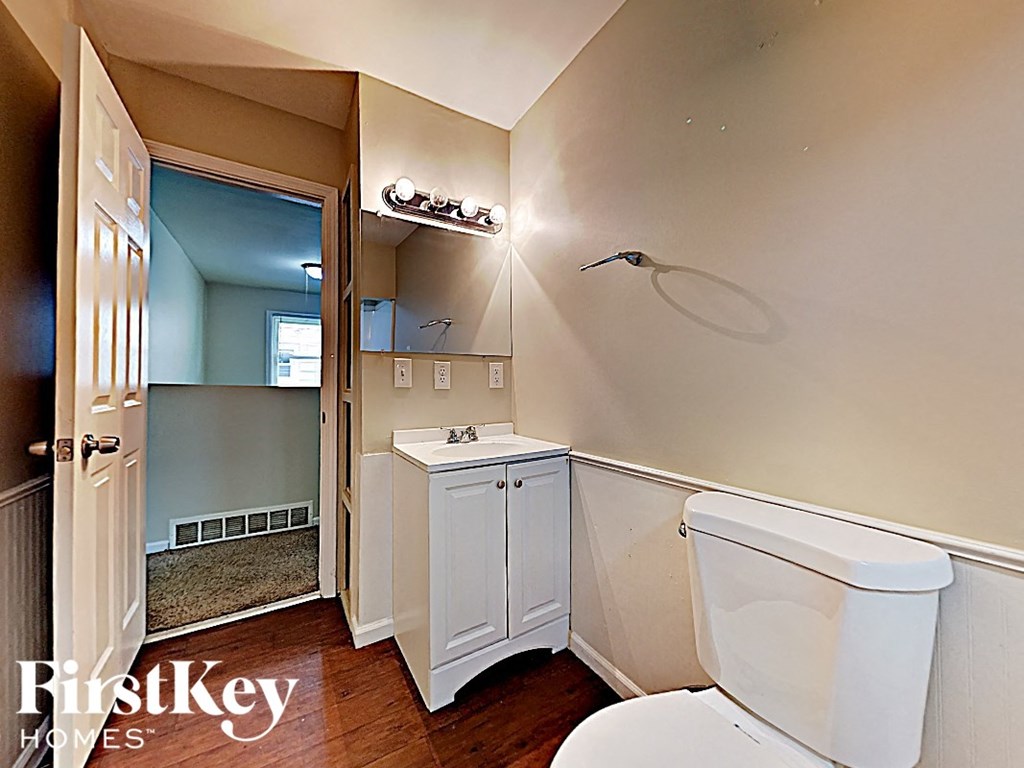 a bathroom with a toilet and a sink and a shower