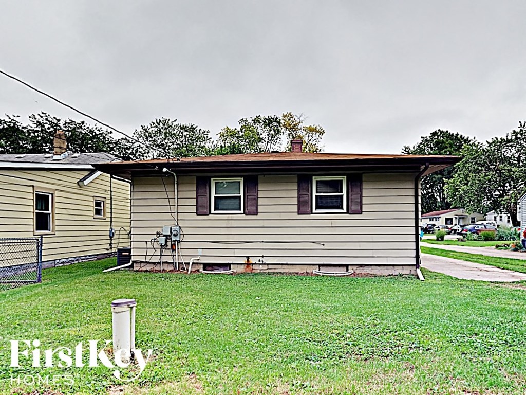 a small house with a yard in front of it