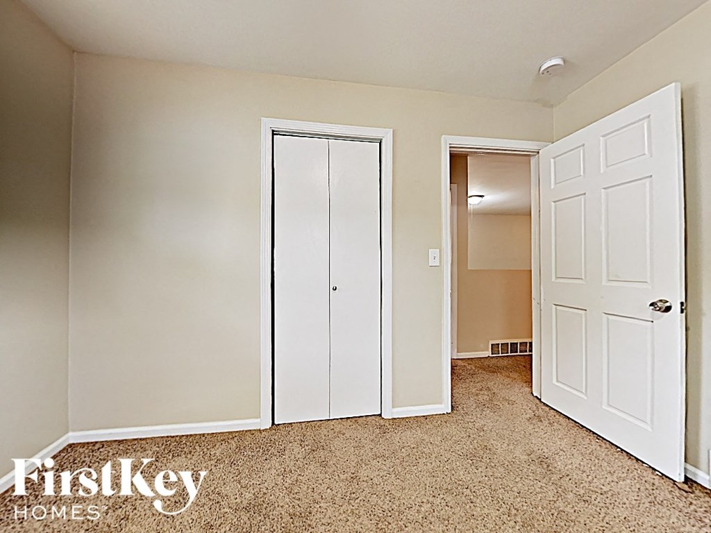 a bedroom with two closets and a door to a bathroom