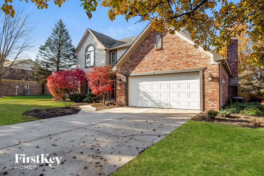 a house with a white garage door and a driveway
