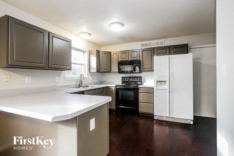 a kitchen with white counter tops and stainless steel appliances
