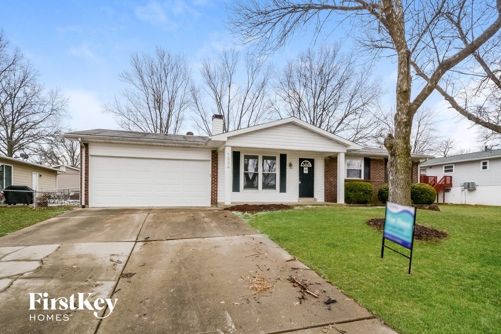 A house with a sign that says FirstKey Homes in front of it.