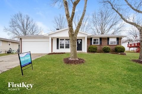 A house with a lawn and a sign that says FirstKey Homes.