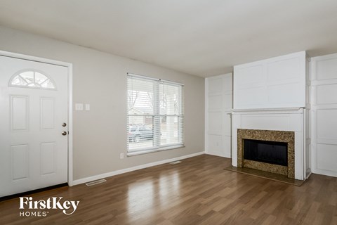 A room with a fireplace and a door.
