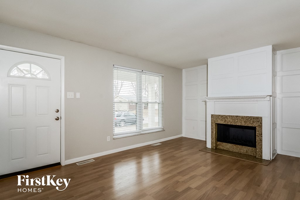 A room with a fireplace and a door.