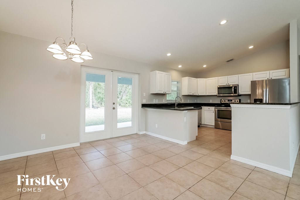 the kitchen is open to the dining room and living room