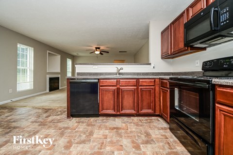 a kitchen with black appliances and wooden cabinets