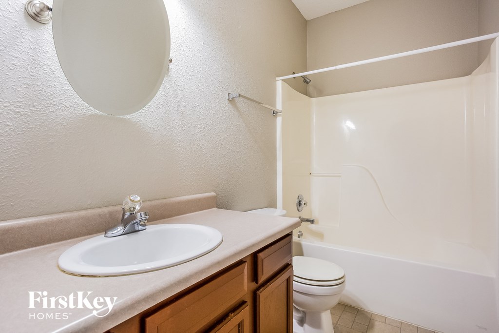 a bathroom with a sink and a toilet and a shower