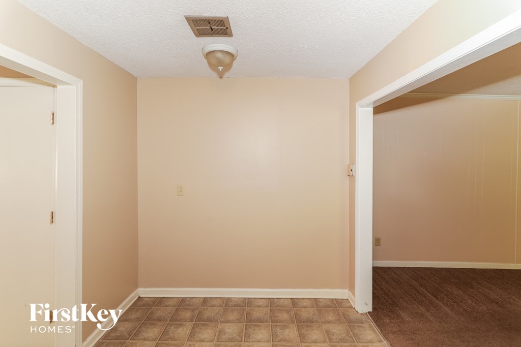A room with a tiled floor and a ceiling light fixture.