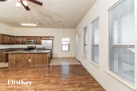 A kitchen with wooden floors and a FirstKey Homes logo.