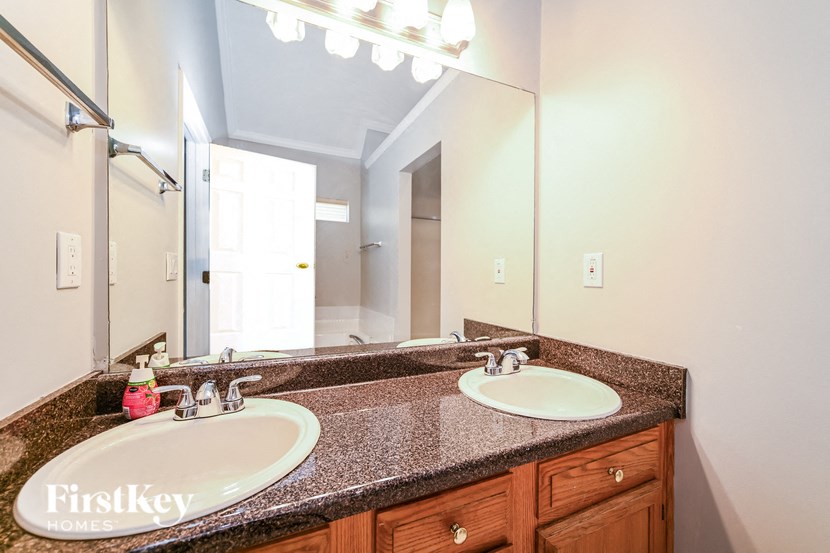 A bathroom with a double sink and a mirror.