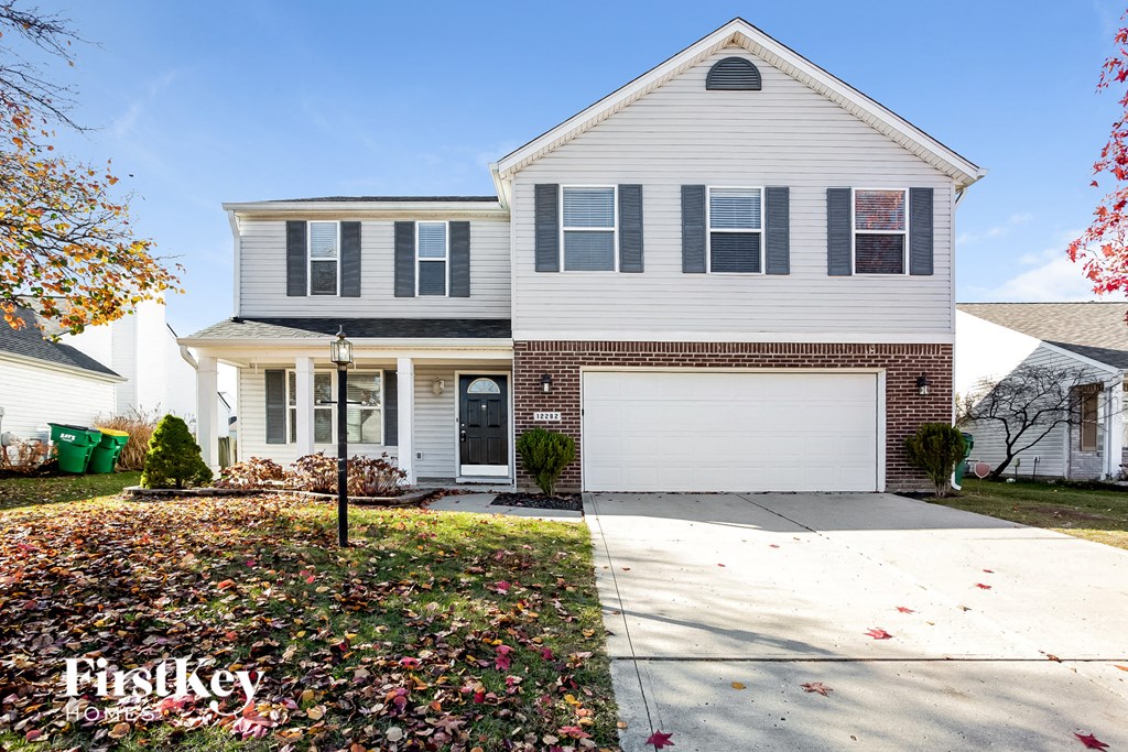 a white house with a white garage door in front of it